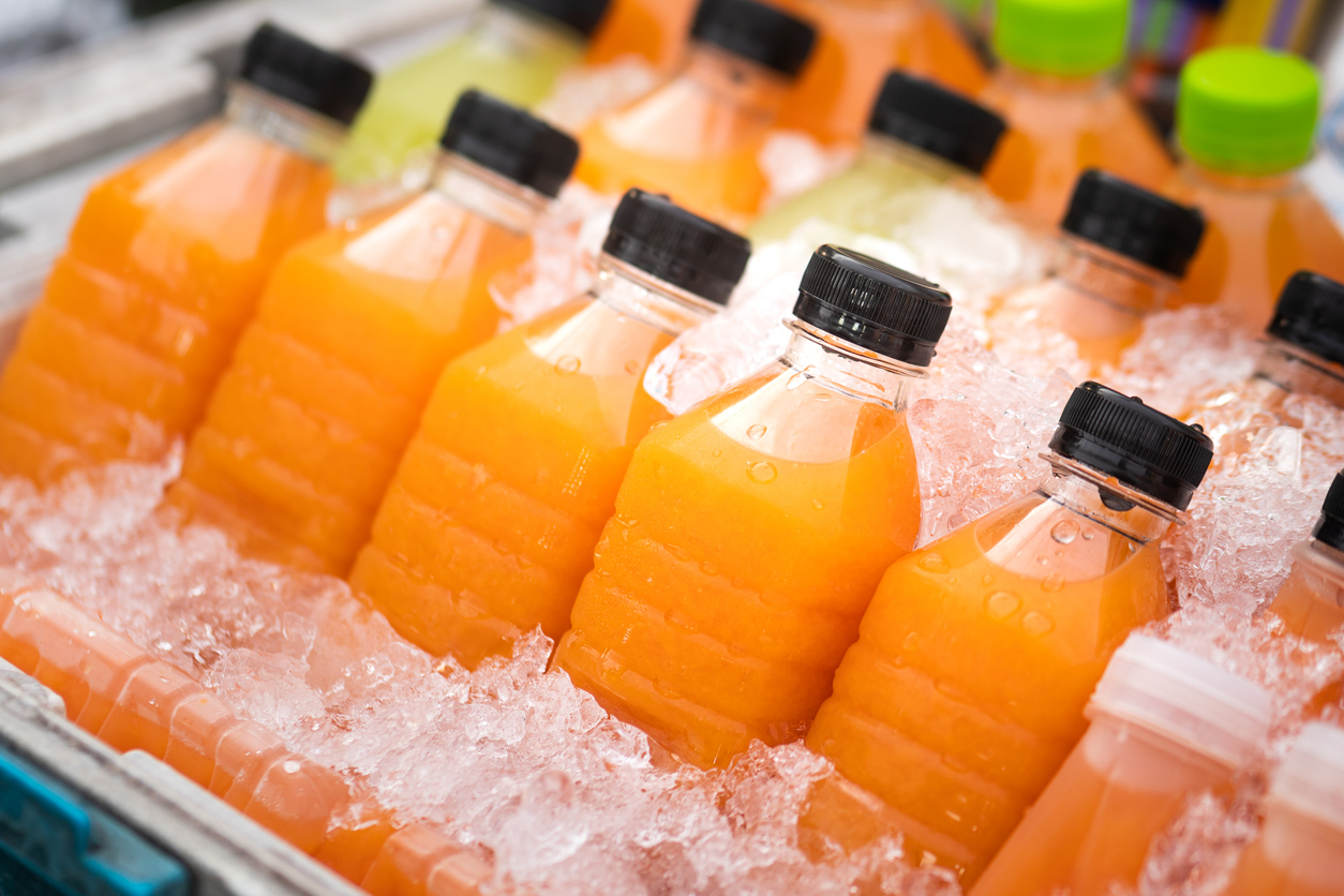 fresh juice in bottles cooled by ice