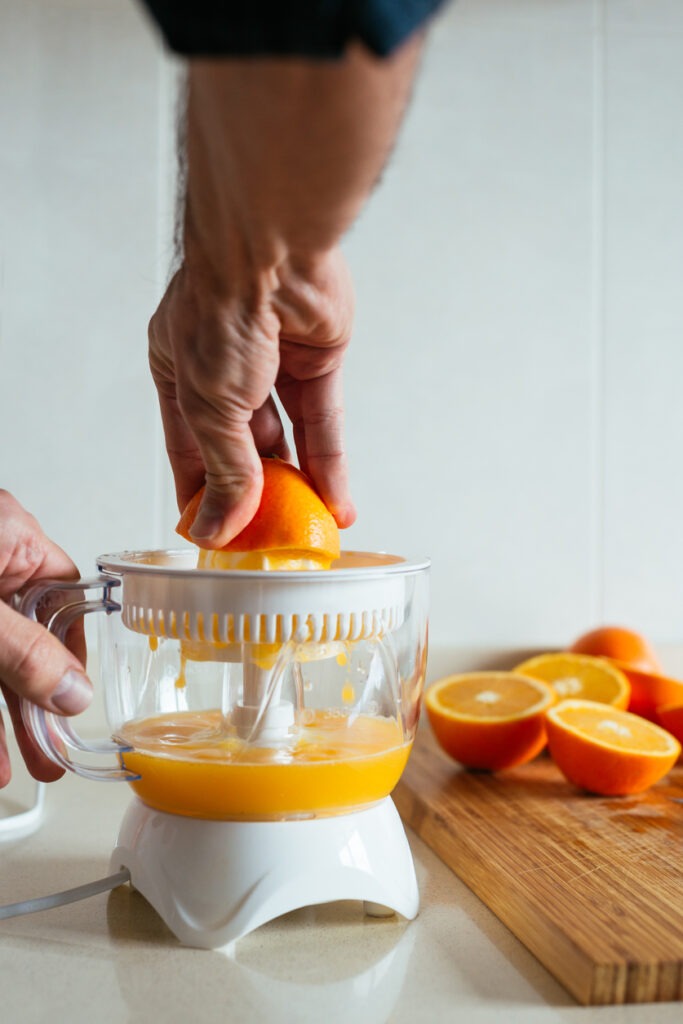 Fresh and ripe fruits using hand press juicer versatility in extracting juice while minimizing heat production