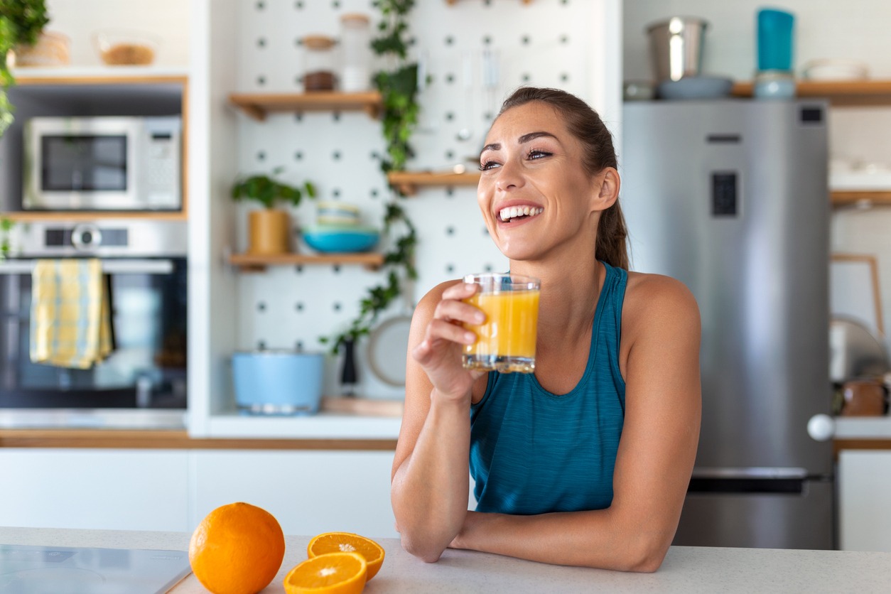 woman drinking fresh orange juice