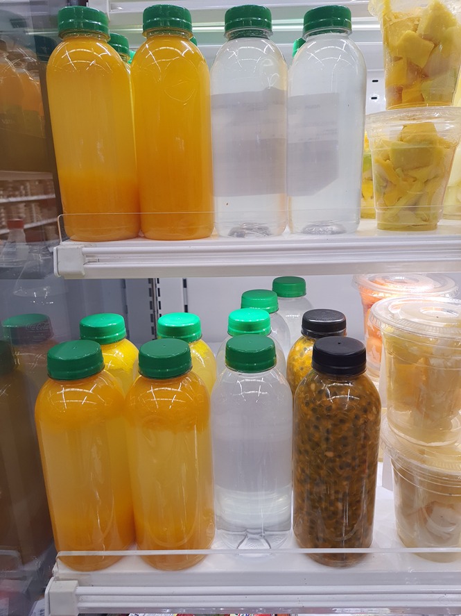 Fresh orange juice, coconut water and passion fruit seed in at a refrigerator